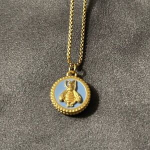 Julie Vos bee necklace with blue background